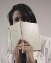 Woman covering her face with a notebook wearing The Dorothy™ Top 2.0 