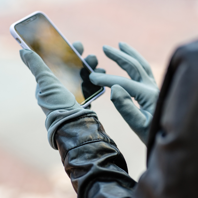 Person texting while wearing the Alice™ Antimicrobial Gloves