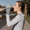 Woman drinking water wearing the Alice™ Antimicrobial Gloves